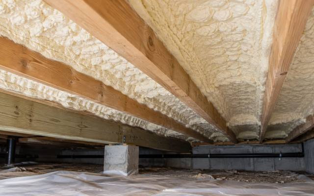 Spray foam under a floor along the joists and rim